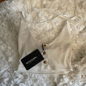 PrettyLittleThing Cream colored ribbed halter top.